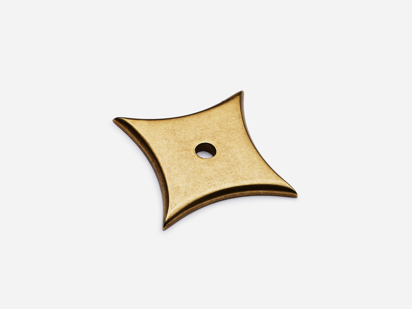 Solid brass 4-Point Star backplate, in an aged brass finish for knobs on cabinets.