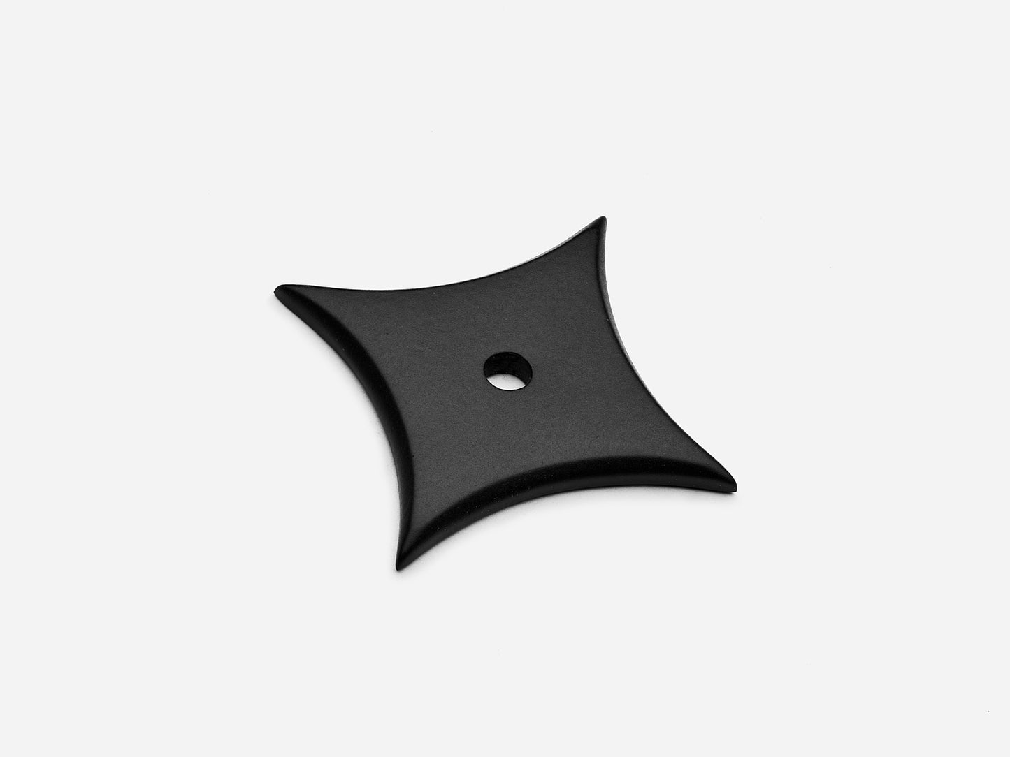 Solid brass 4-Point Star backplate, in a matte black finish for knobs on cabinets.