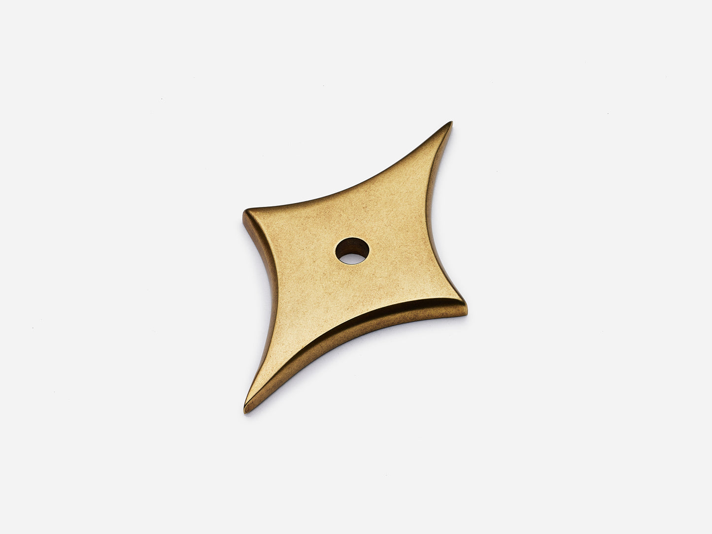 Solid brass 4-Point Tall Star backplate, in an aged brass finish for knobs on cabinets.