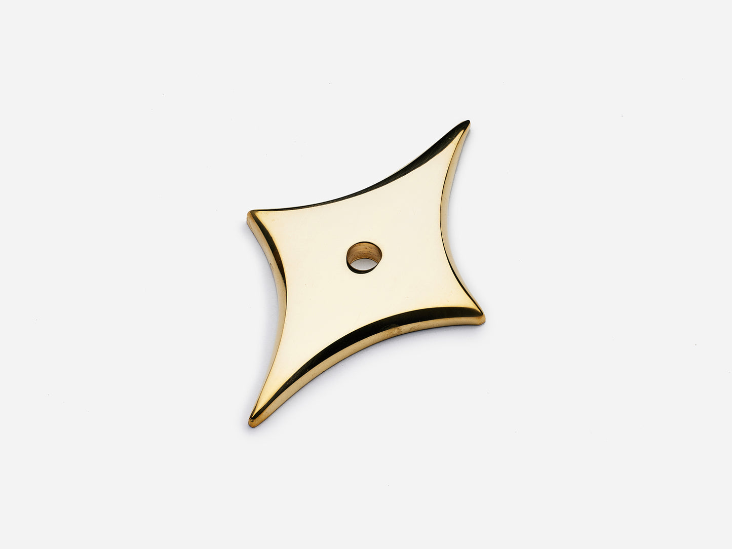 Solid brass 4-Point Tall Star backplate, in an unlacquered polished brass finish for knobs on cabinets.