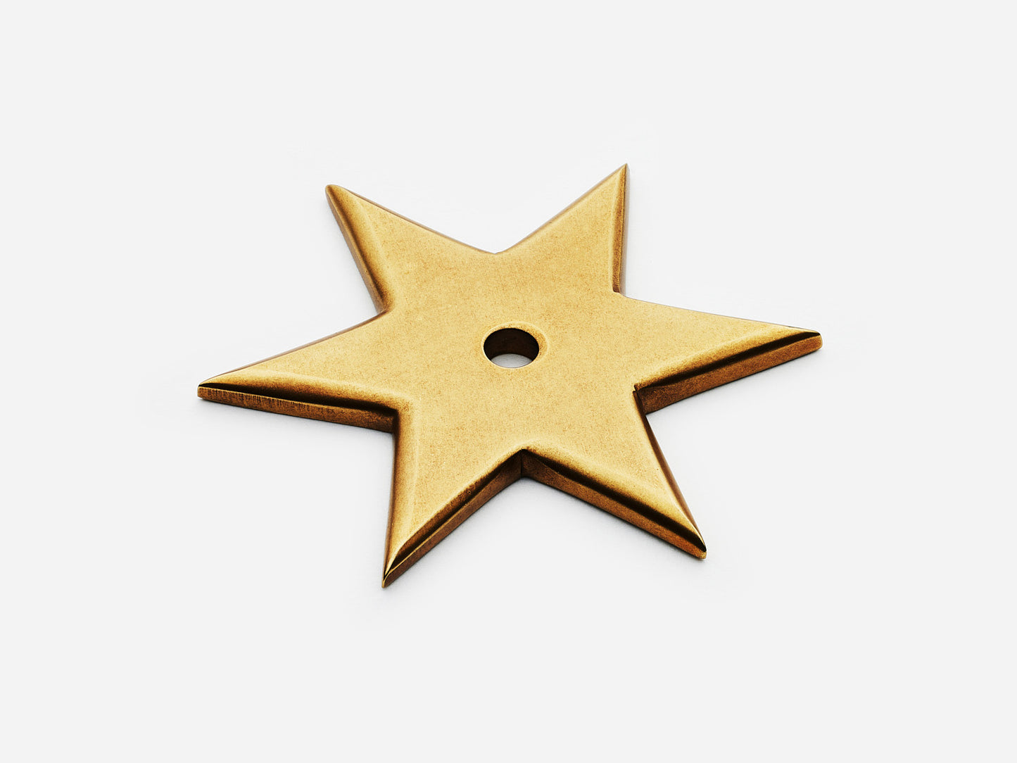Solid brass 6-Point Star backplate, in an aged brass finish for knobs on cabinets.