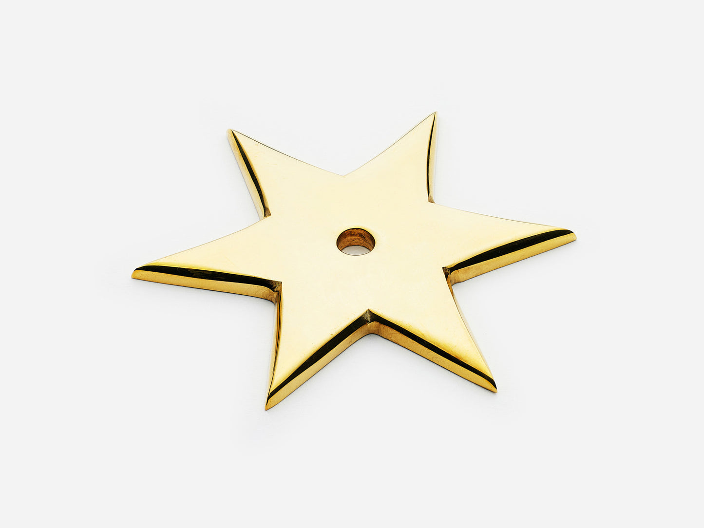 Solid brass 6-Point Star backplate, in an unlacquered polished brass finish for knobs on cabinets.
