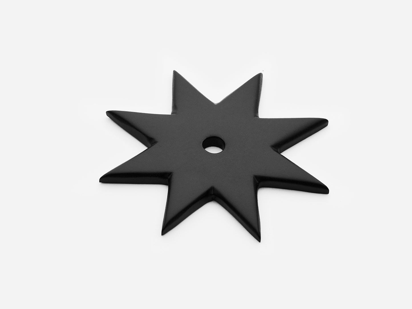 Solid brass 8-Point Star backplate, in a matte black finish for knobs on cabinets.