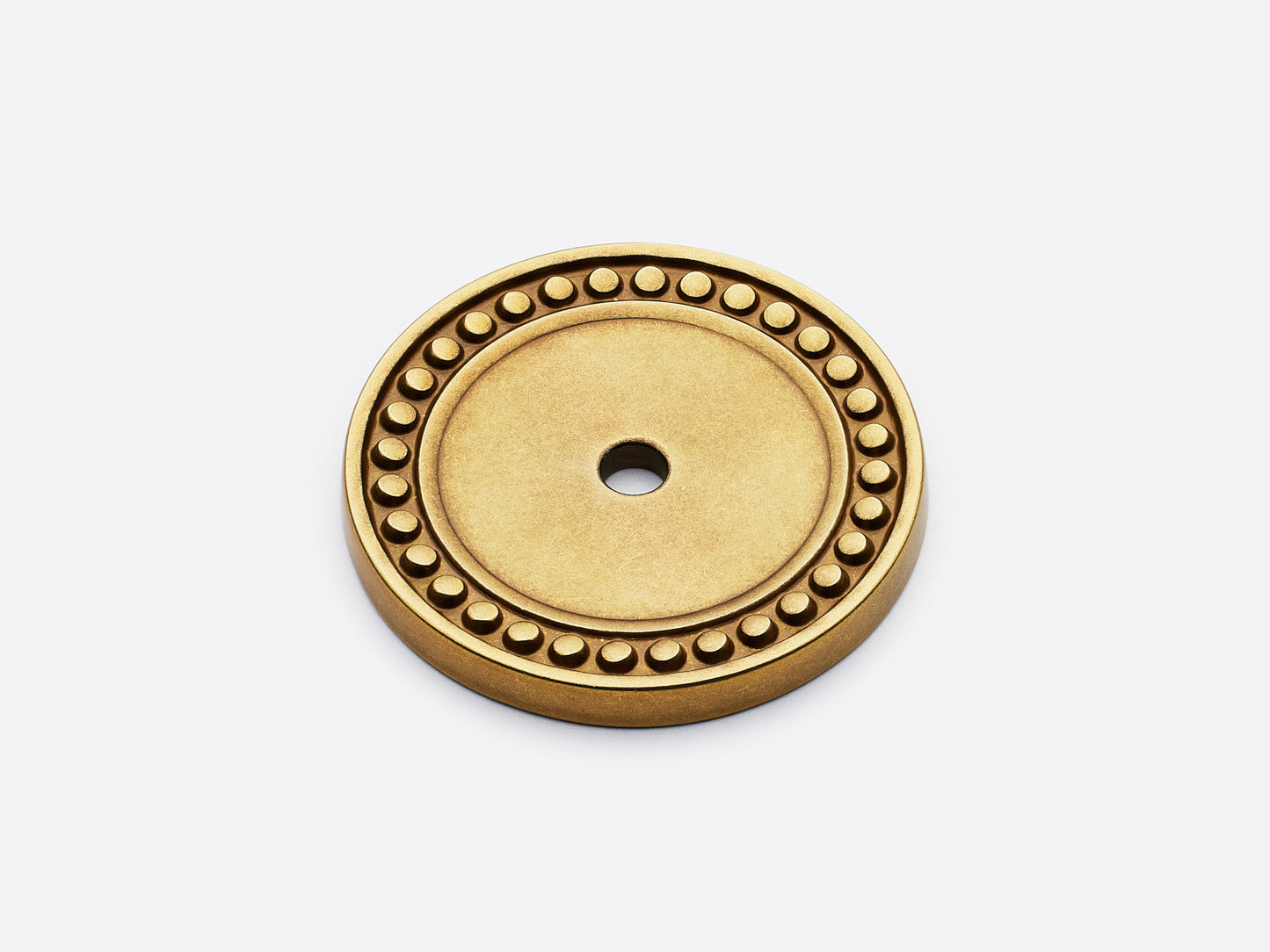 Solid brass Beaded Round backplate, in an aged brass finish for knobs on cabinets.
