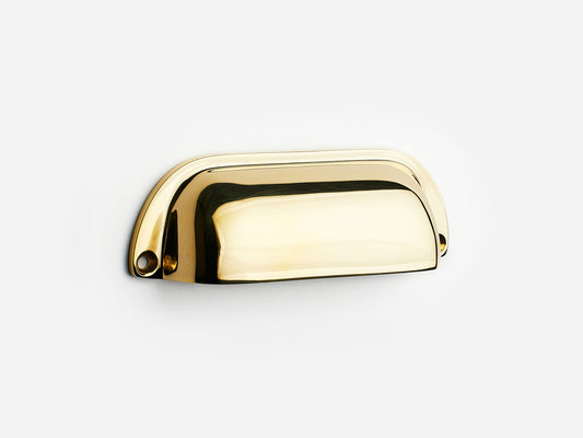 Solid brass Dane bin pull, 4 inches, in an unlacquered polished brass finish for cabinets.