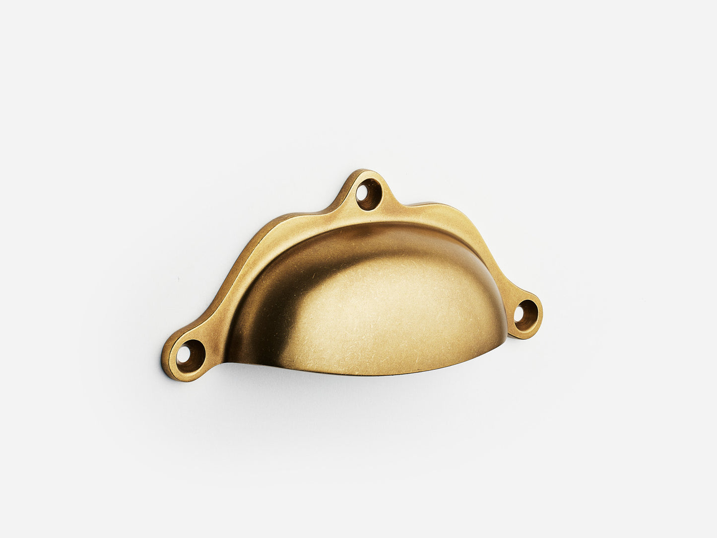 Solid brass Grace bin pull, 4 inches, in an aged brass finish for cabinets.