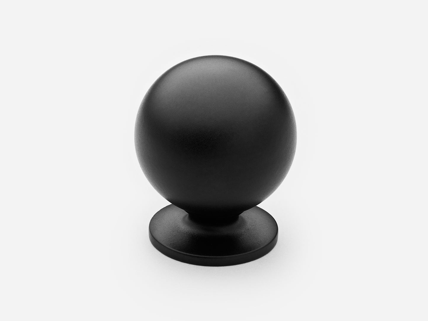 Solid brass Luxe Ball Knob, large size, in a matte black finish for cabinets.
