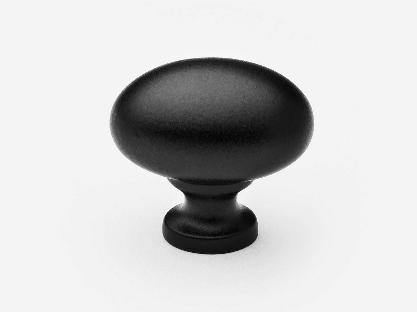 Solid brass Oval Knob, standard size, in a matte black finish for cabinets.