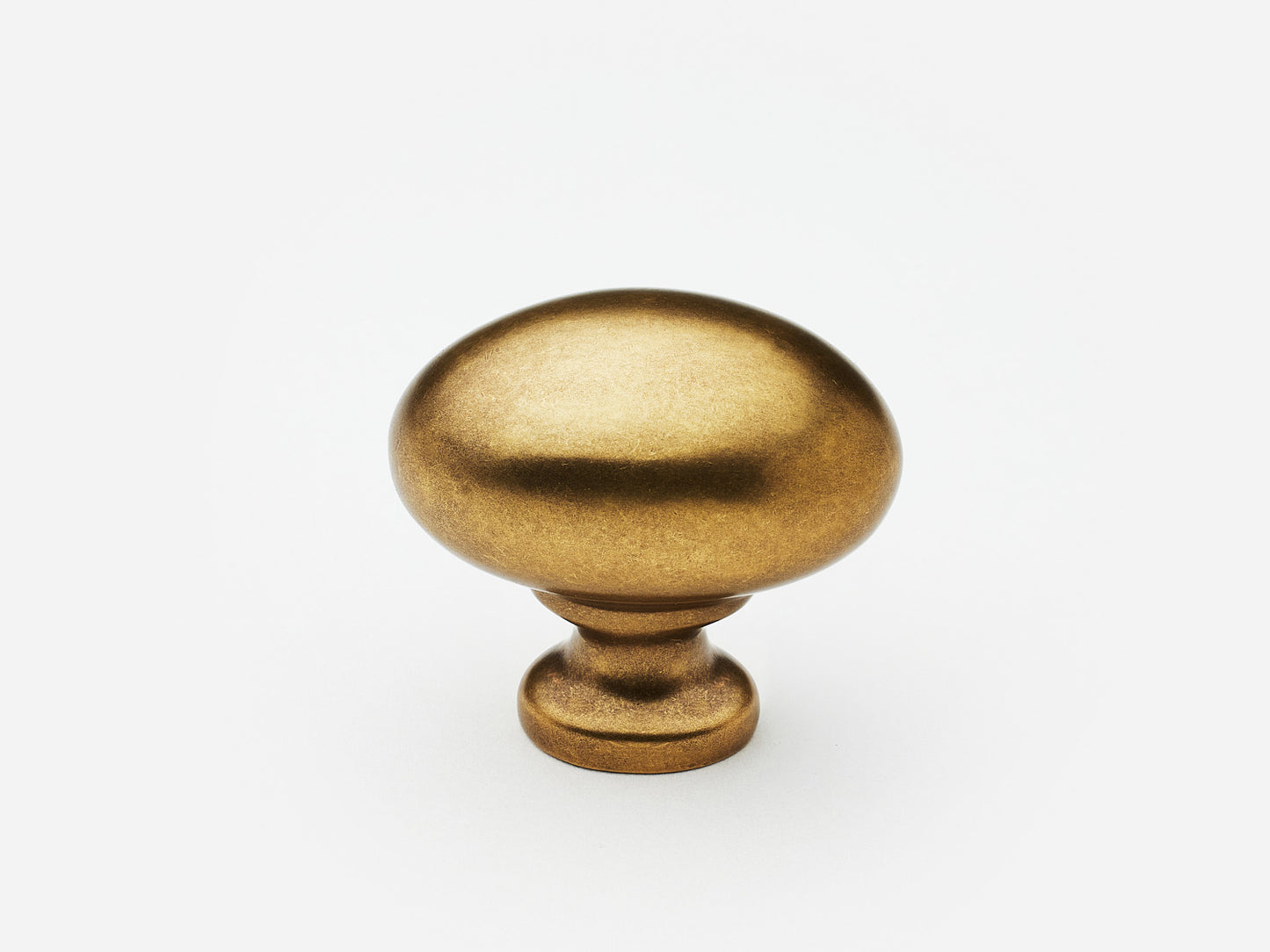 Solid brass Oval Knob, standard size, in an aged brass finish for cabinets.