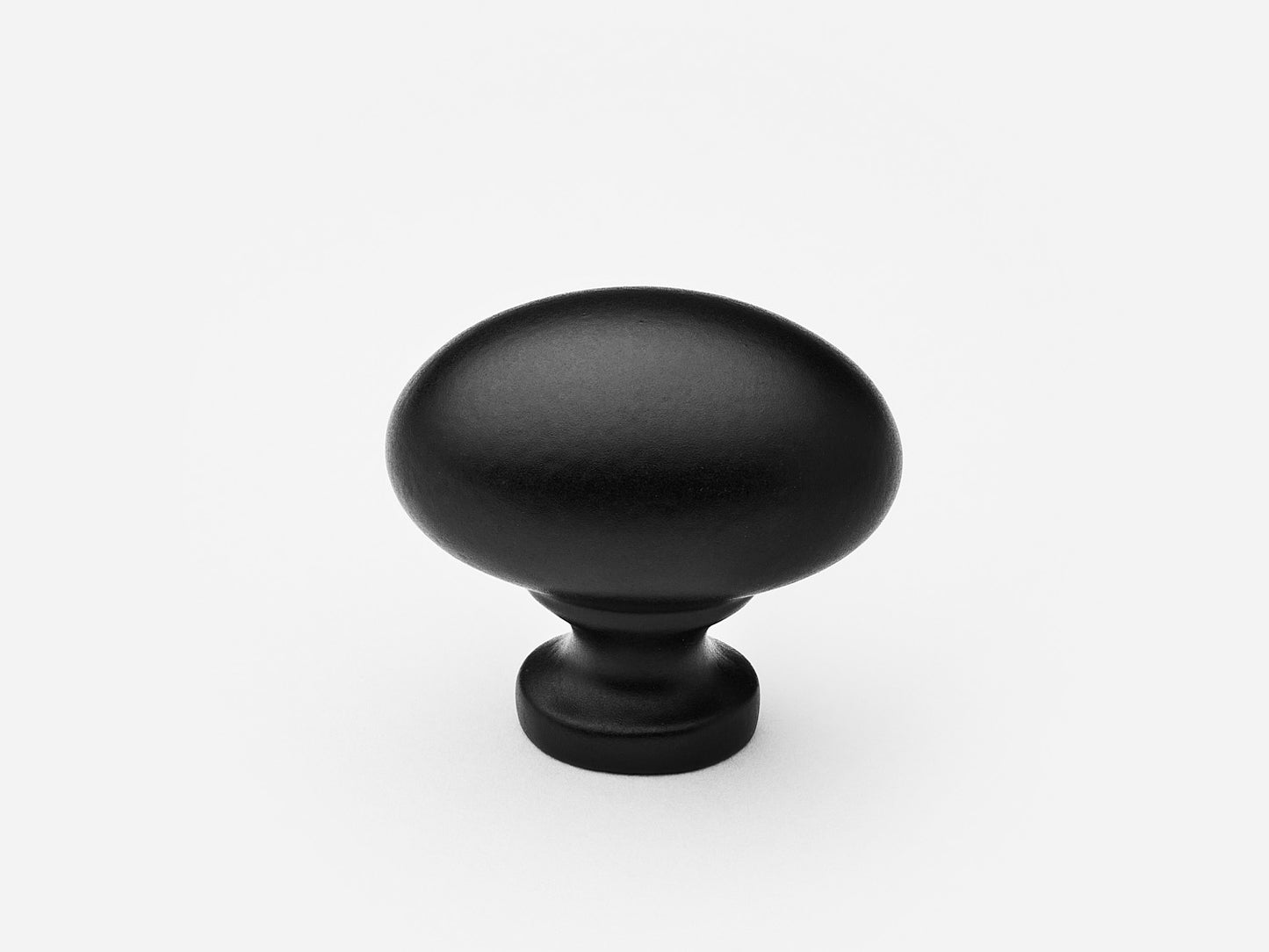 Solid brass Oval Knob, standard size, in a matte black finish for cabinets.