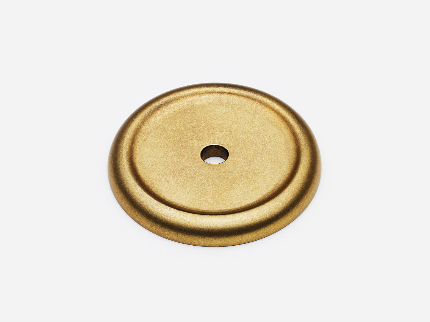 Solid brass Raised Round backplate, in an aged brass finish for knobs on cabinets.