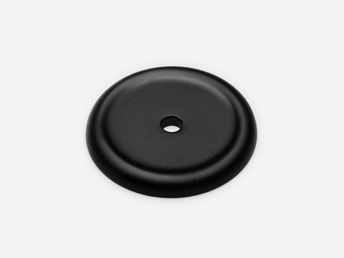 Solid brass Raised Round backplate, in a matte black finish for knobs on cabinets.
