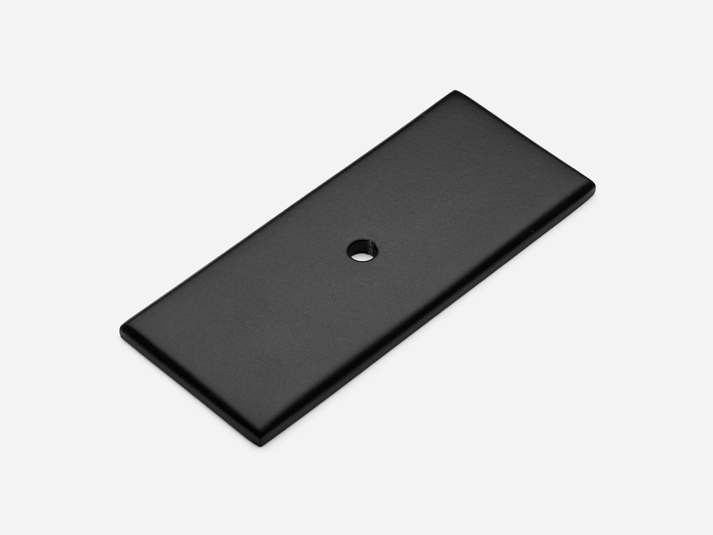 Solid brass rectangular backplate, 1.25x3 inches, matte black finish for knobs and pulls on cabinets.