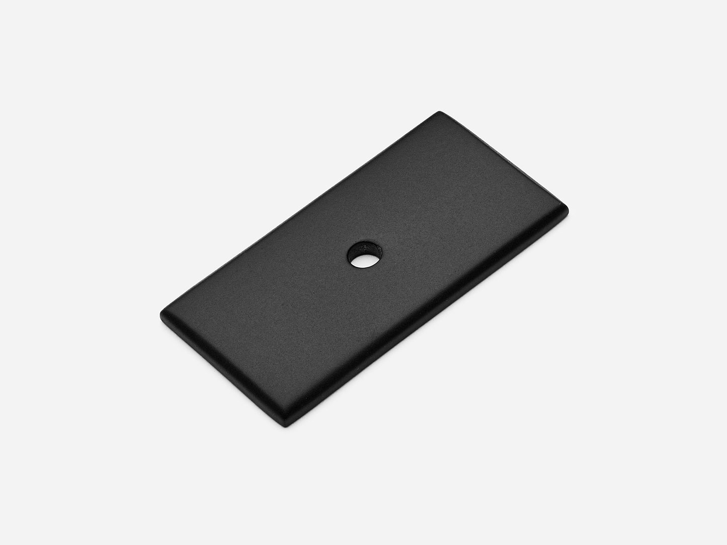 Solid brass rectangular backplate, 1x2 inches, matte black finish for knobs and pulls on cabinets.