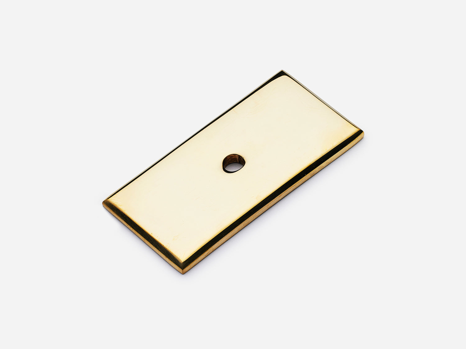 Solid brass rectangular backplate, 1x2 inches, unlacquered polished brass finish for knobs and pulls on cabinets.