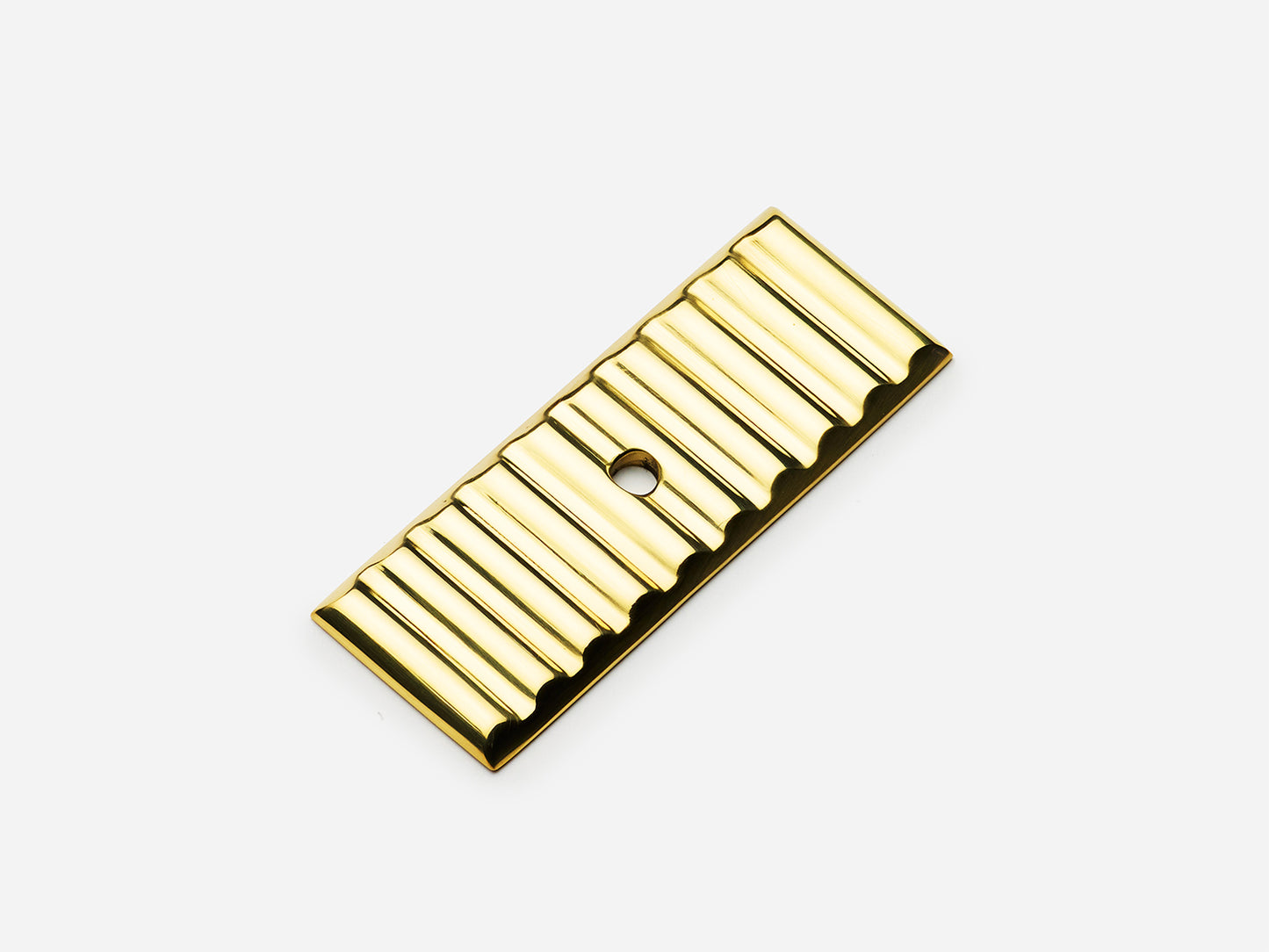 Solid brass Reeded backplate, 1x2.5 inches, in an unlacquered polished brass finish for knobs on cabinets.