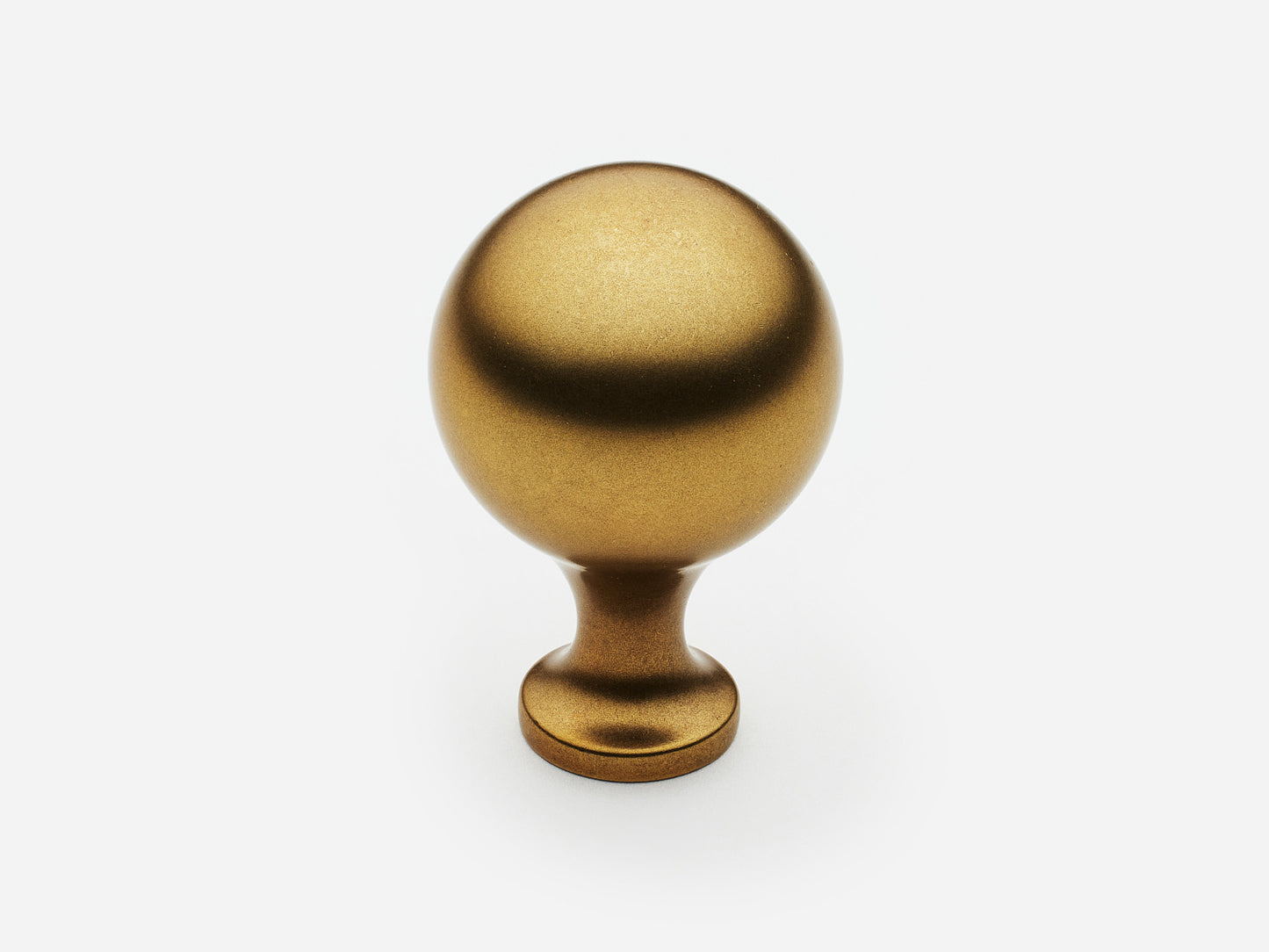 Solid brass Serenity Knob, large size, in an aged brass finish for cabinets.