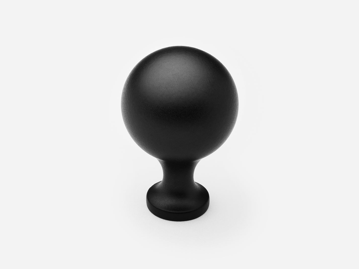 Solid brass Serenity Knob, large size, in a matte black finish for cabinets.