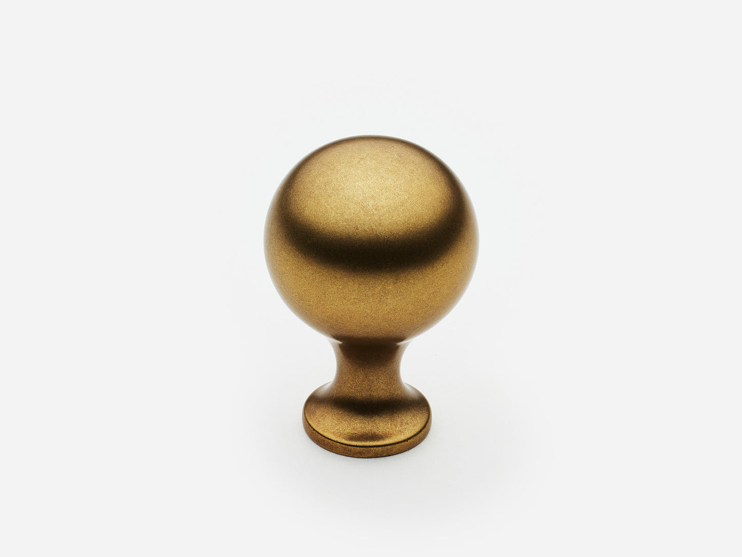 Solid brass Serenity Knob, standard size, in an aged brass finish for cabinets.