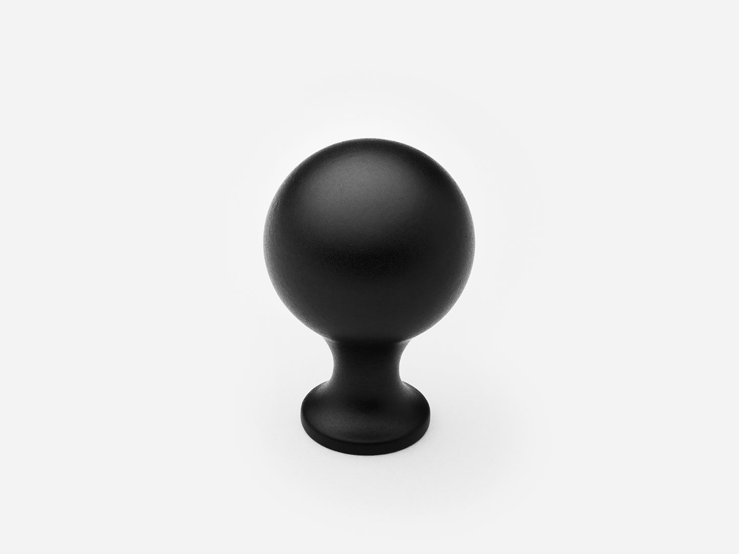 Solid brass Serenity Knob, standard size, in a matte black finish for cabinets.