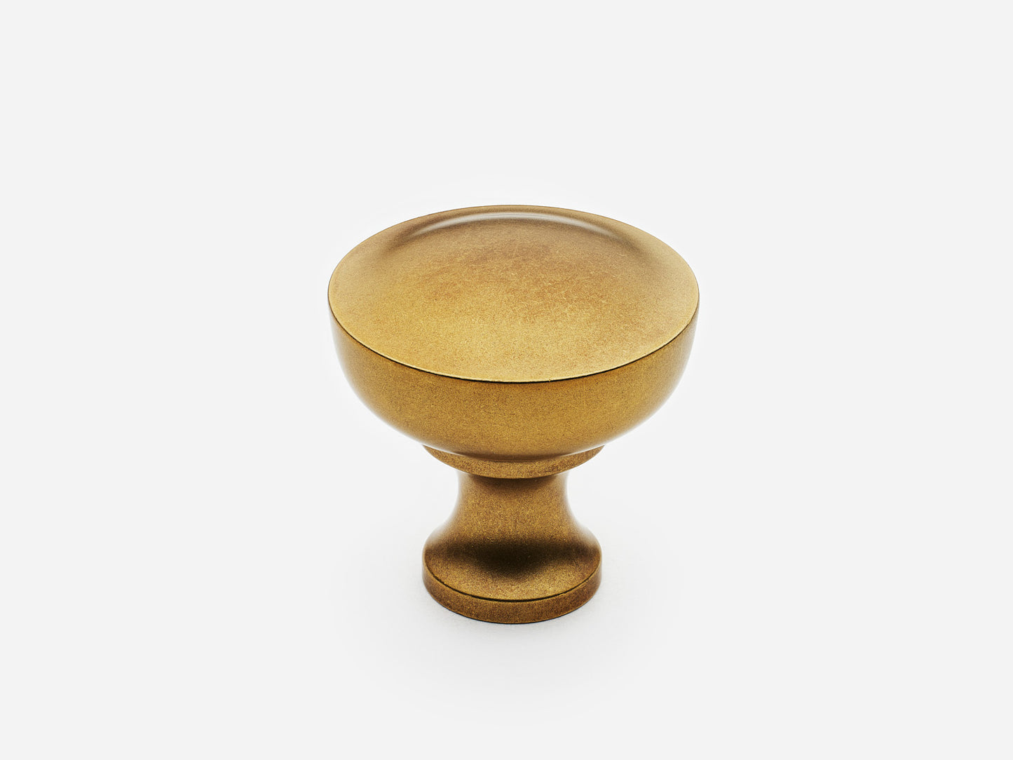 Solid brass Triumph Knob, standard size, in an aged brass finish for cabinets.