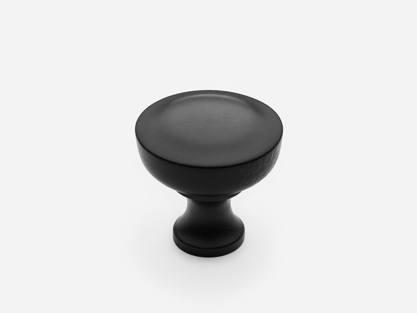 Solid brass Triumph Knob, standard size, in a matte black finish for cabinets.