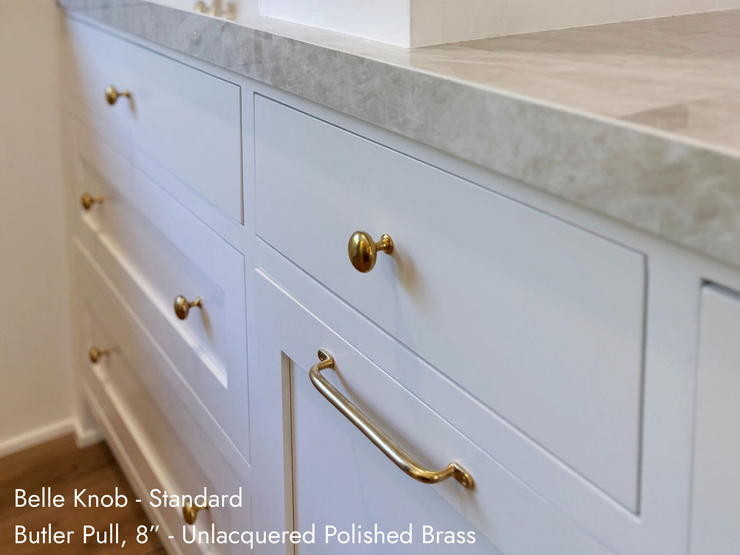 Solid brass Butler Pull, in unlacquered polished brass finish, on kitchen cabinets.
