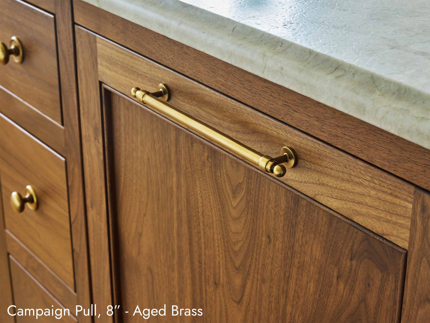 Solid brass Campaign Pull, in aged brass finish, on kitchen cabinets.