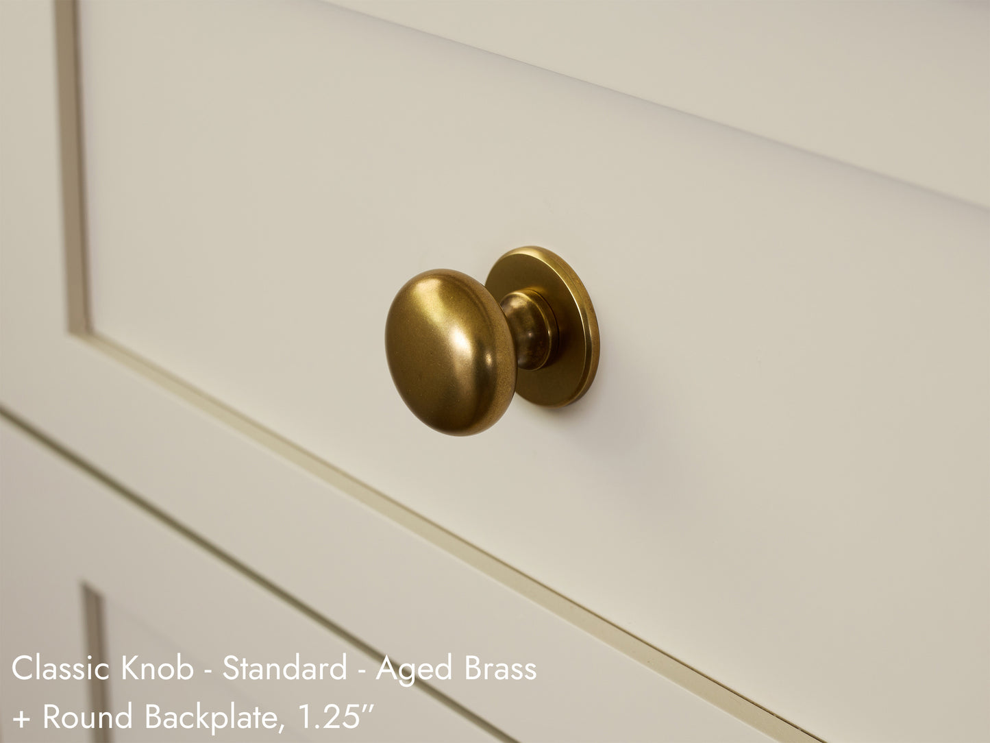 Solid brass Classic Knob, in aged brass finish, on kitchen cabinets with Round Backplate.