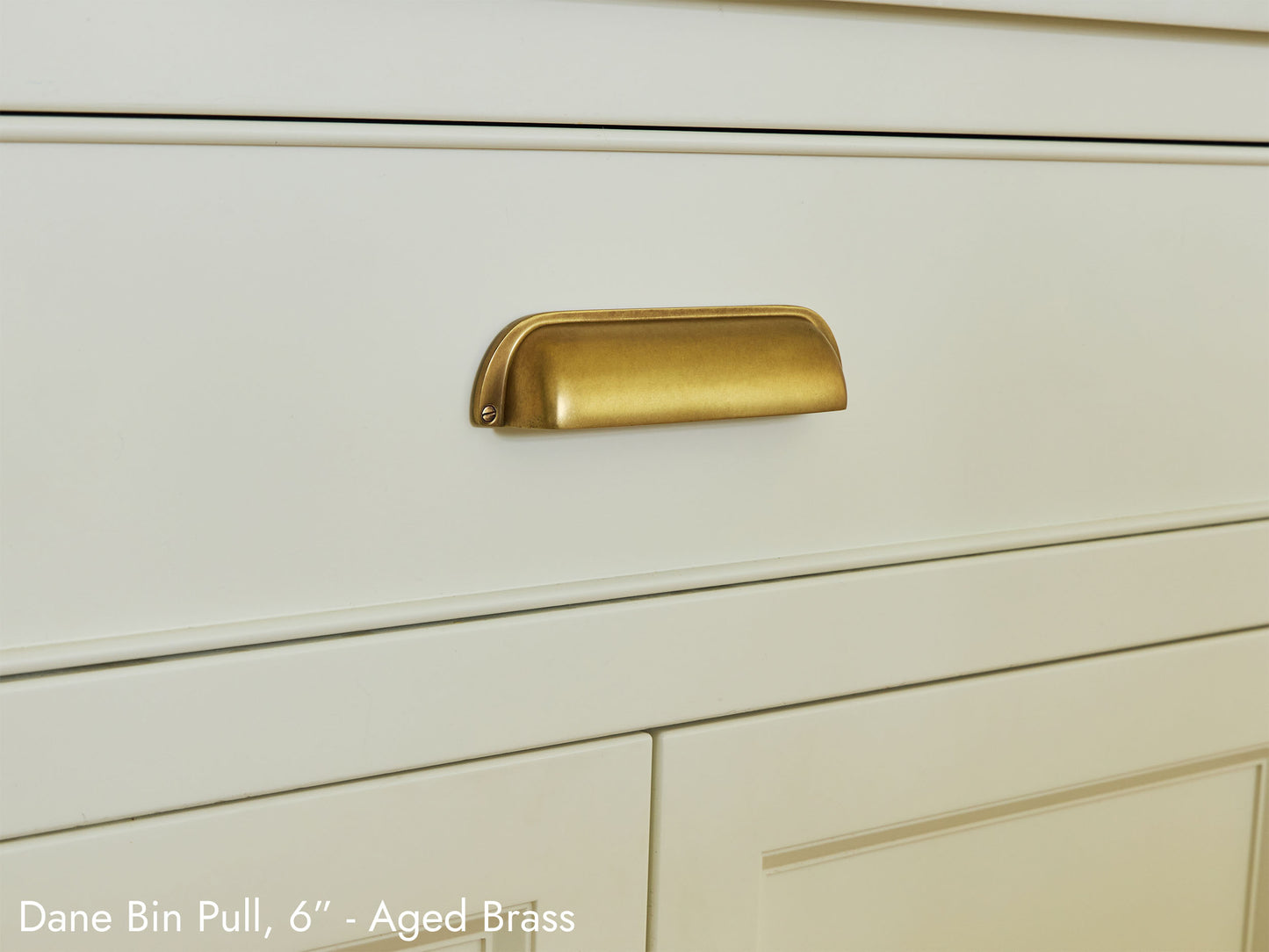 Solid brass Dane Bin Pull, in aged brass, on kitchen cabinets.