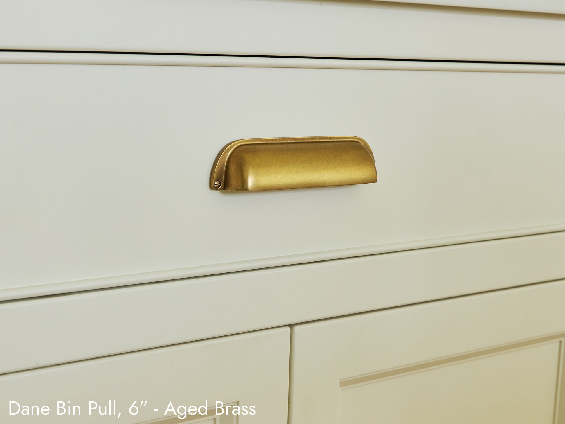 Solid brass Dane Bin Pull, in aged brass, on kitchen cabinets.