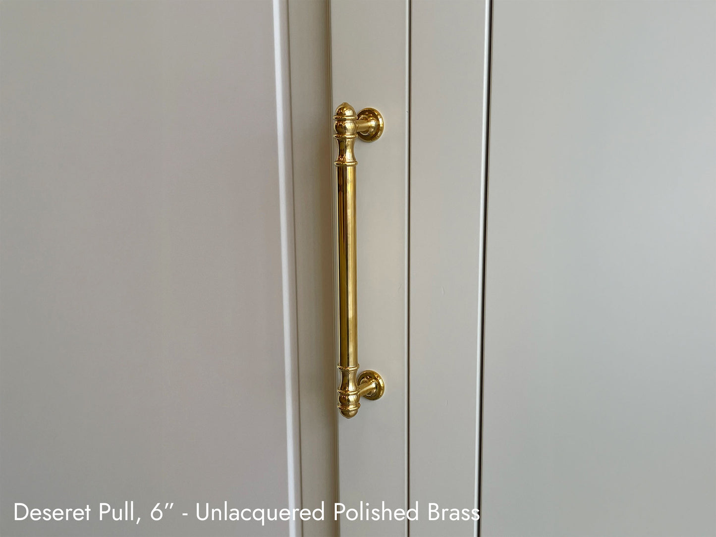 Solid brass Deseret Pull, in unlacquered polished brass finish, on kitchen cabinets.