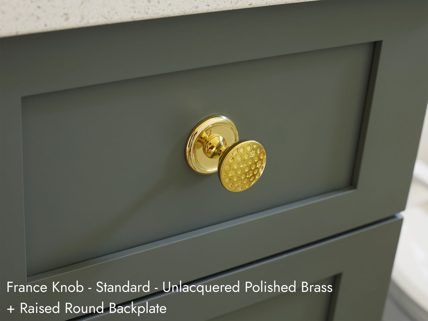 Solid brass France Knob, in unlacquered polished brass finish, on kitchen cabinets with Raised Round Backplate.