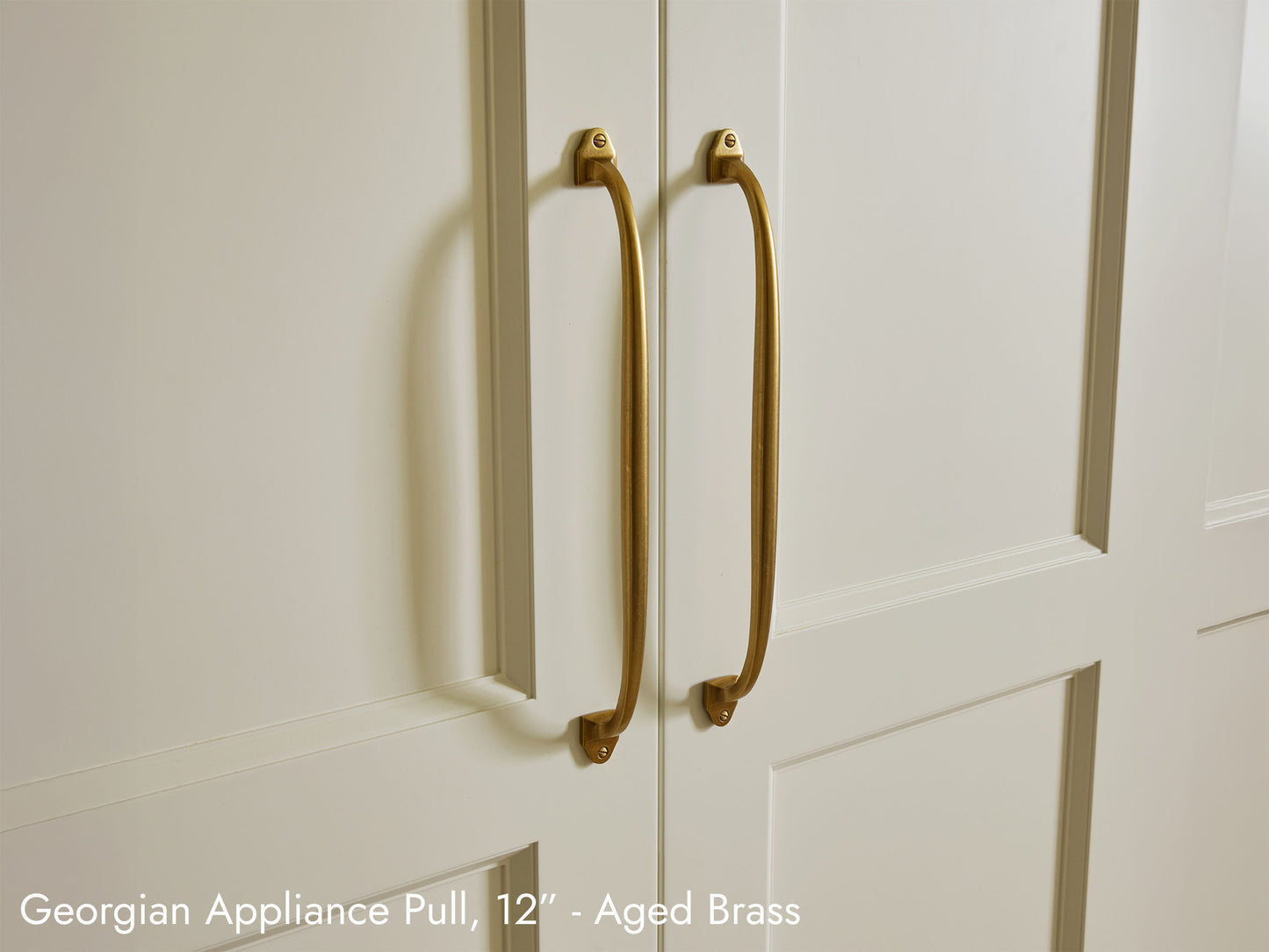 Solid brass Georgian Appliance Pulls, in aged brass finish, on kitchen cabinets.