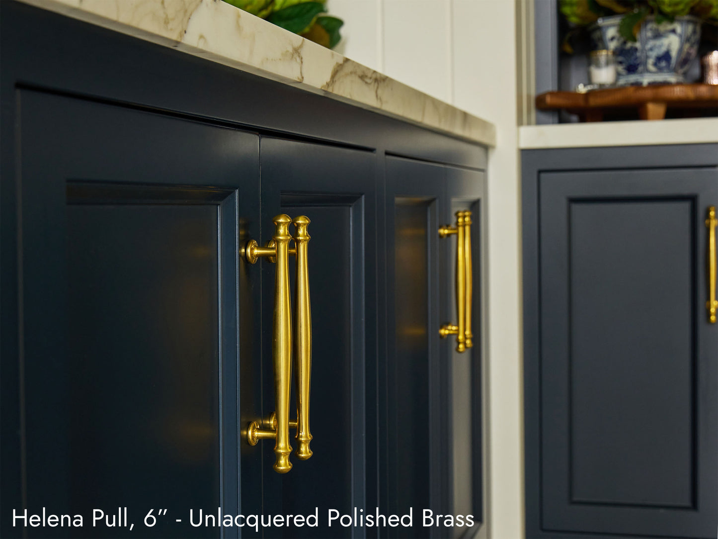 Solid brass Helena Pulls, in unlacquered polished brass finish, on kitchen cabinets.