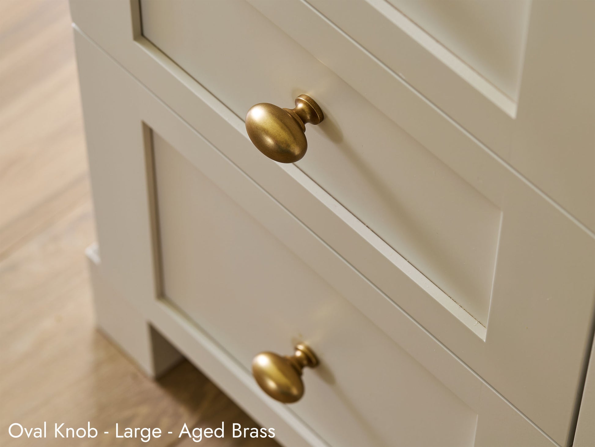 Solid brass Oval Knob, in aged brass finish, on kitchen cabinets.