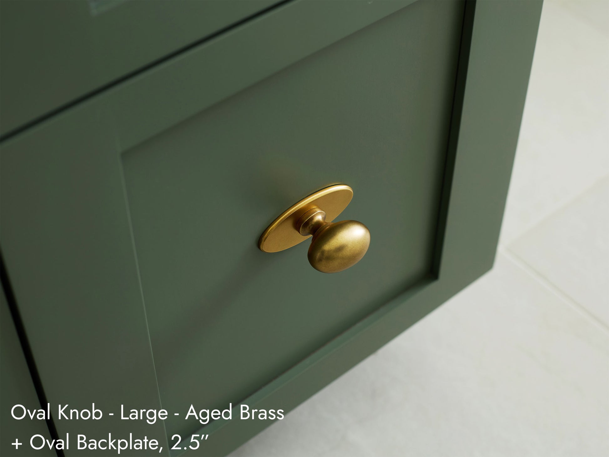 Solid brass Oval Knob, in aged brass finish, on kitchen cabinets with Oval Backplate.