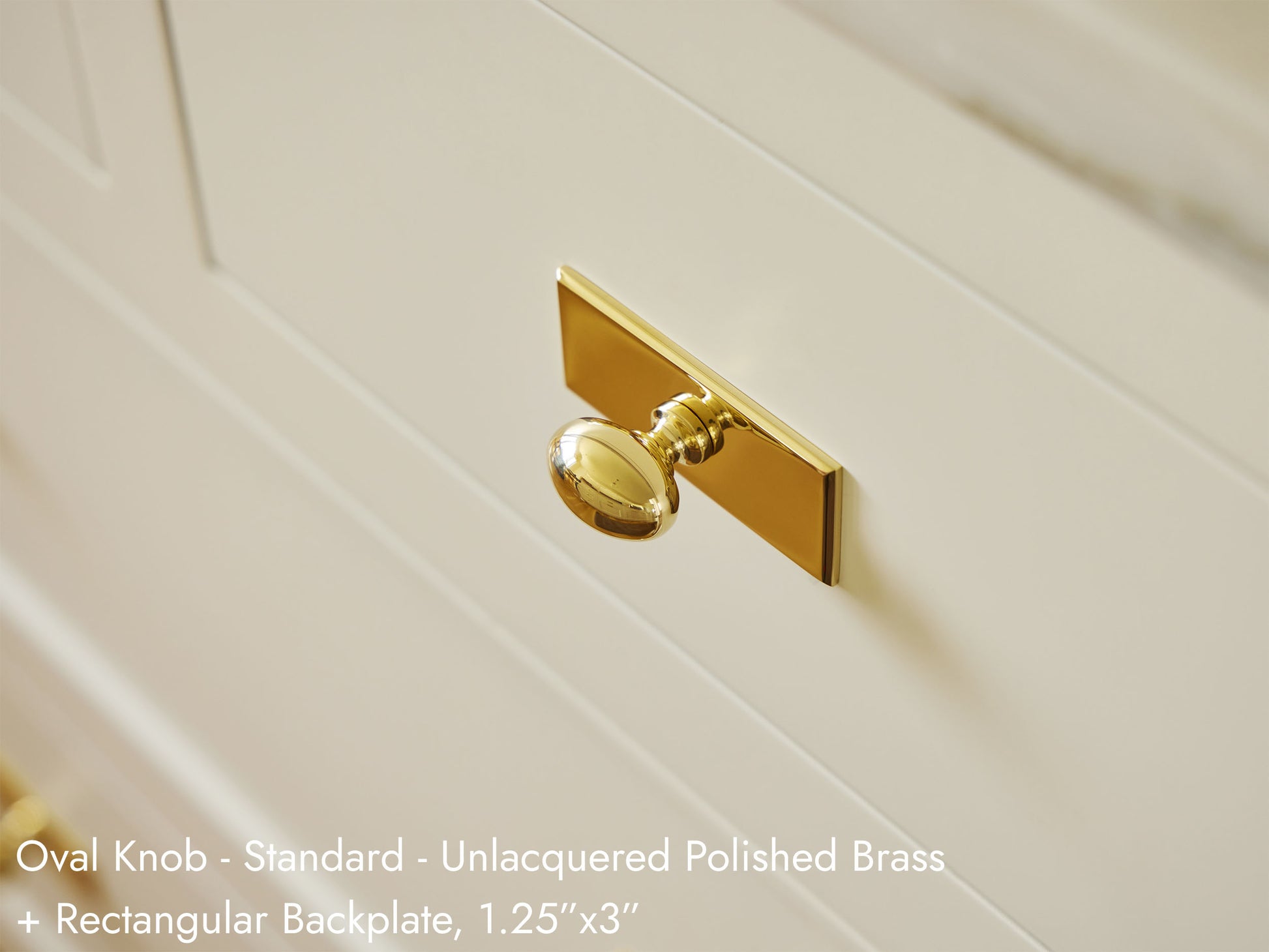 Solid brass Oval Knob with a Rectangular Backplate on kitchen cabinets.