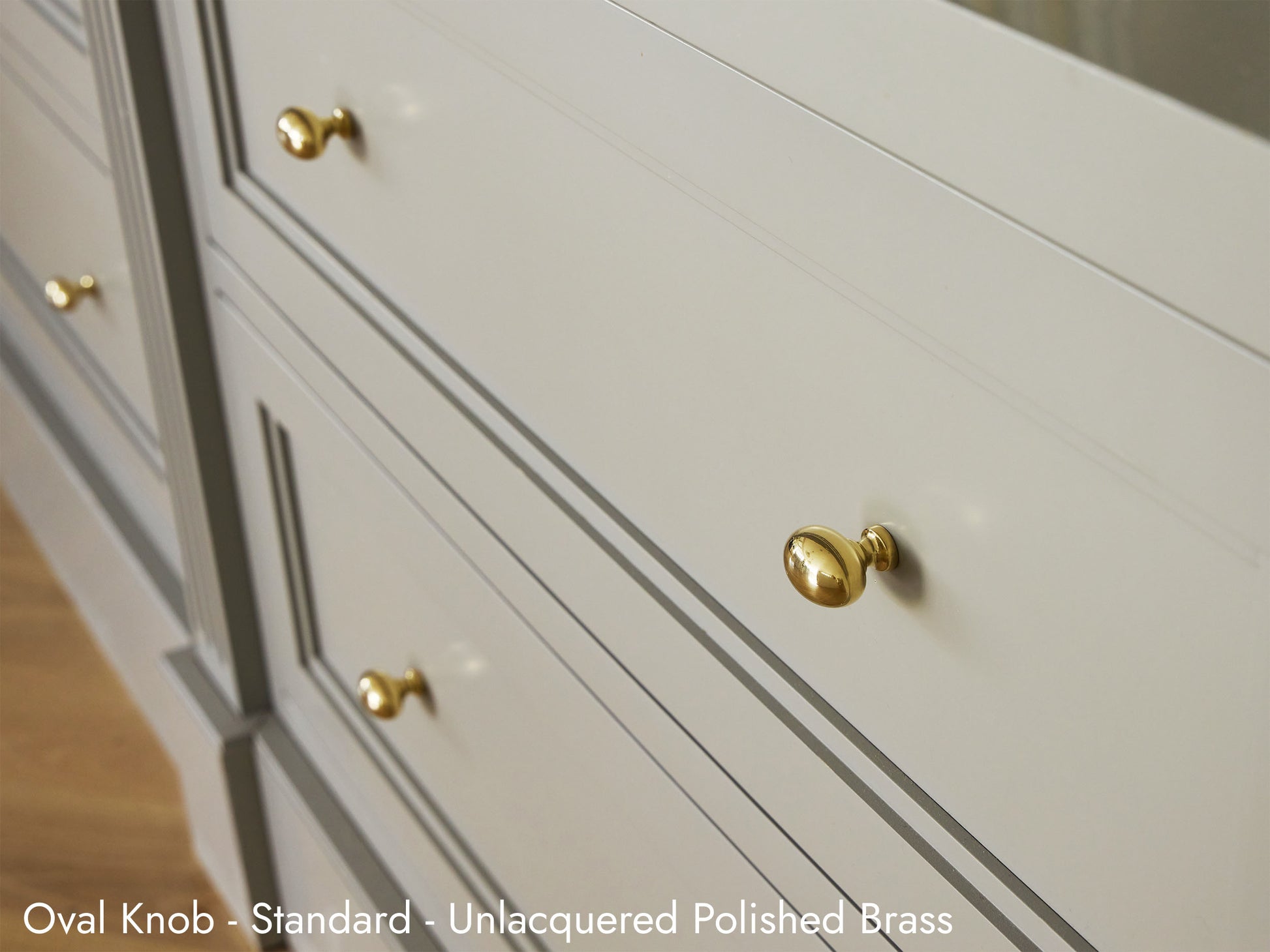 Solid brass Oval Knob in unlacquered polished brass on kitchen cabinets.
