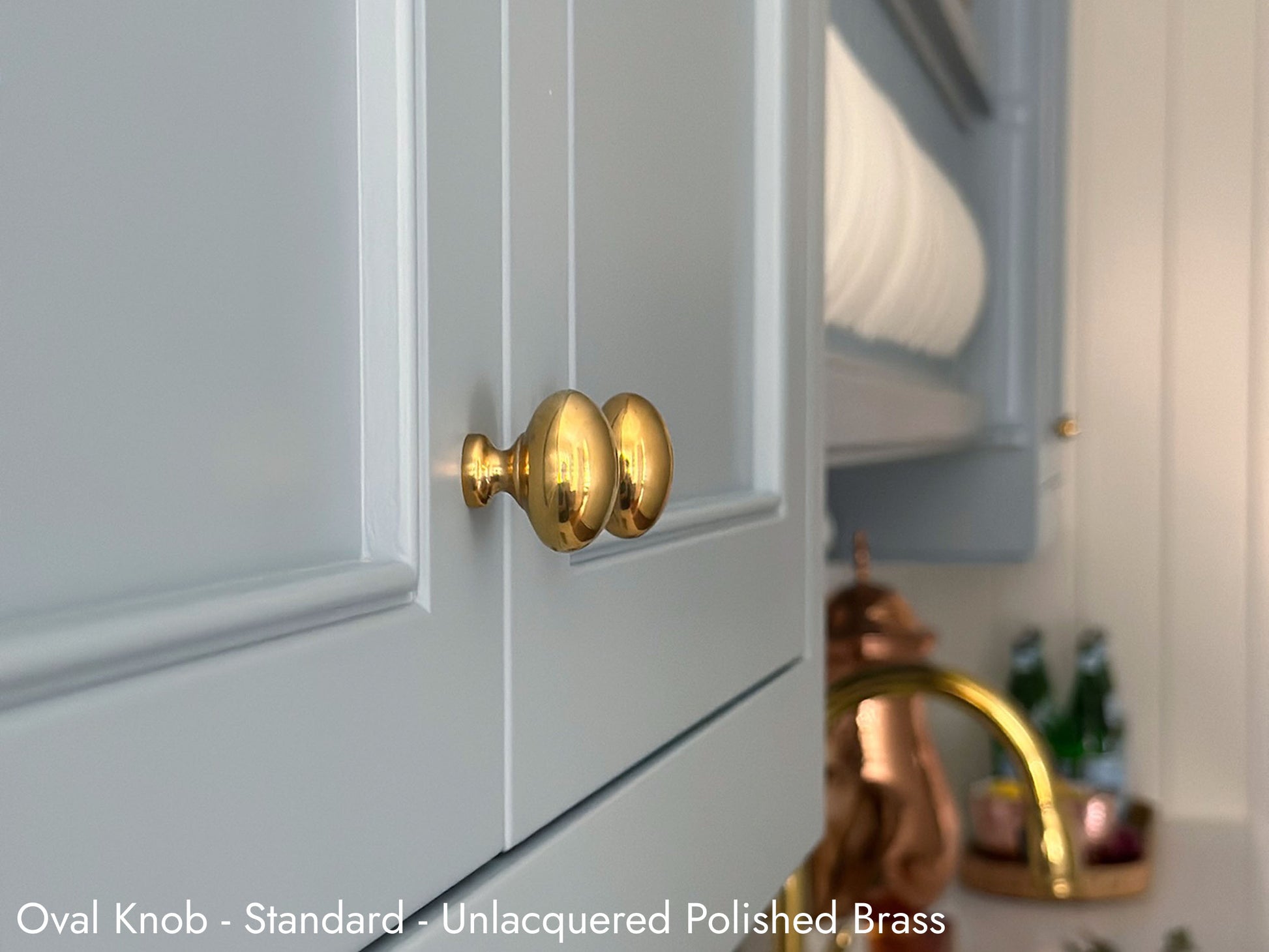 Solid brass Oval Knob in unlacquered polished brass on kitchen cabinets.