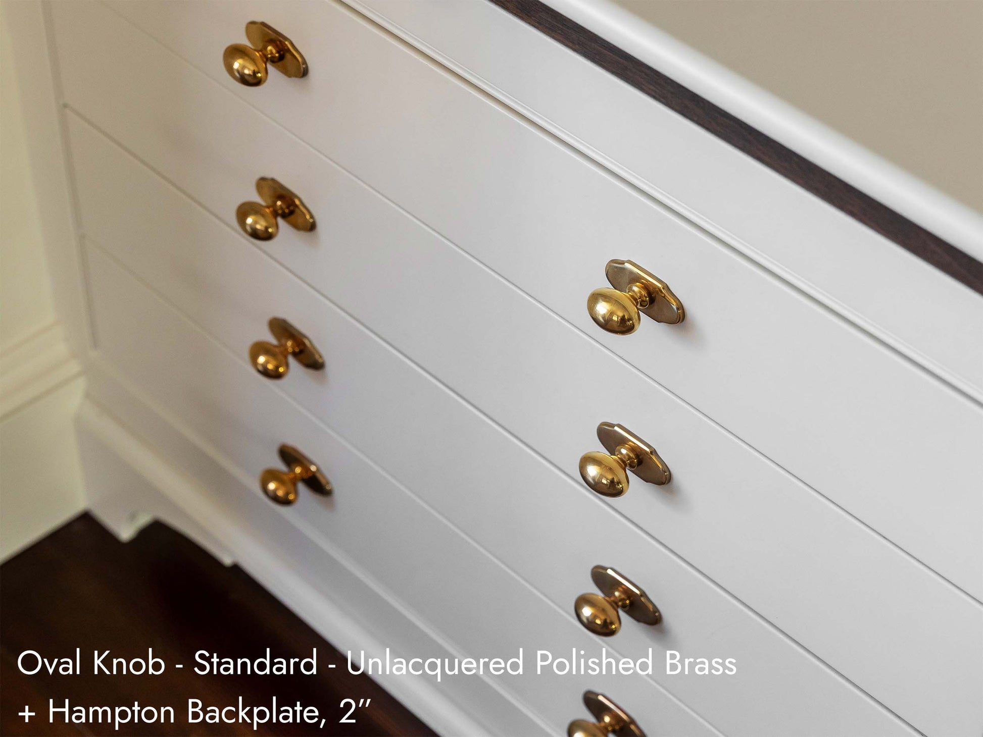 Solid brass Oval Knobs, in unlacquered polished brass, on kitchen cabinets.