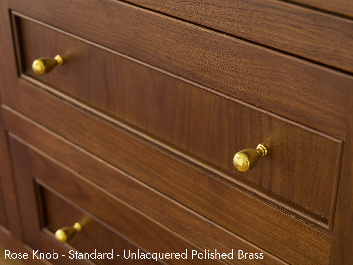 Solid brass Rose Knob in unlacquered polished brass finish on a kitchen island cabinet.