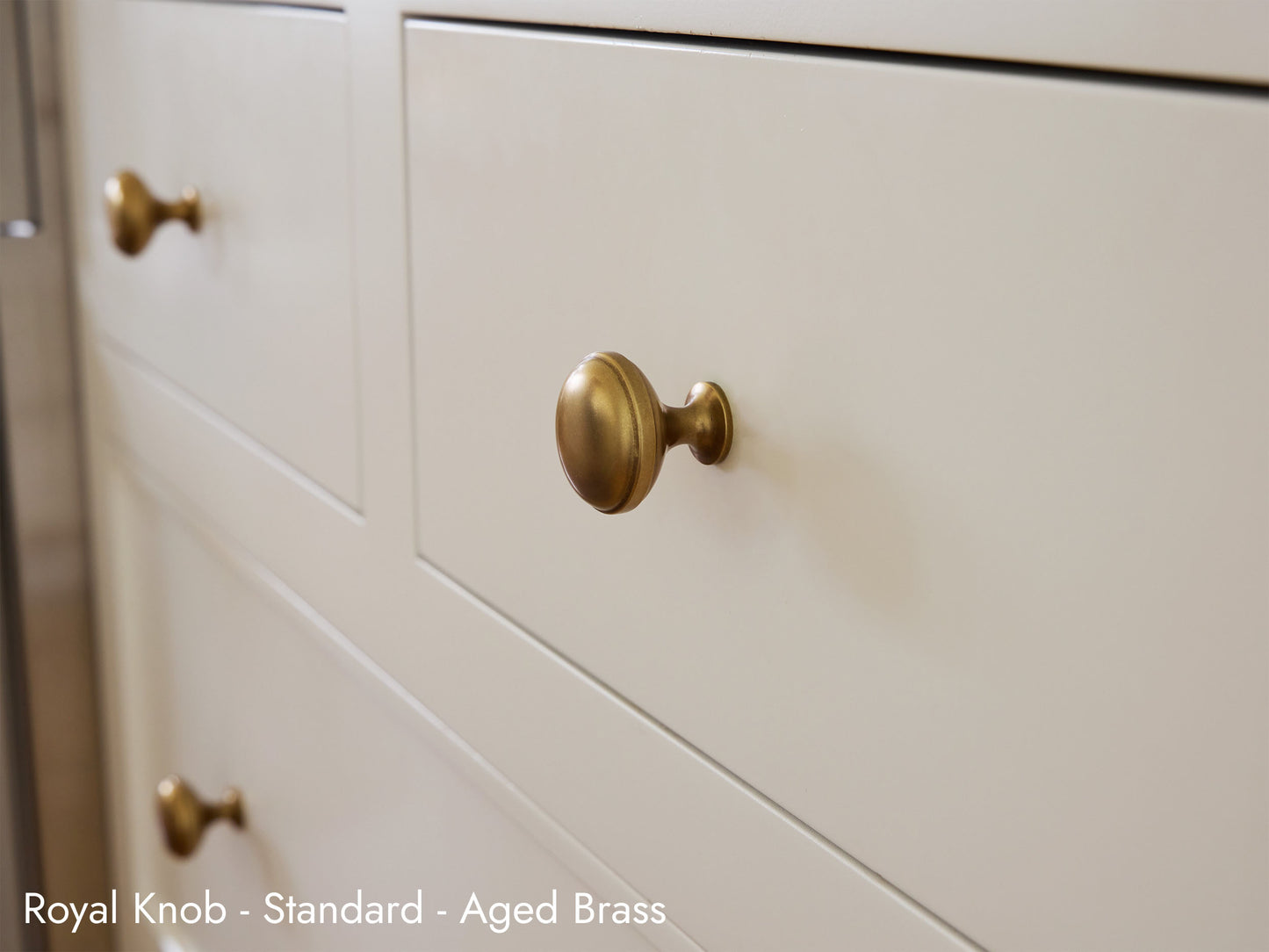 Solid brass Royal Knob in aged brass on kitchen cabinets.