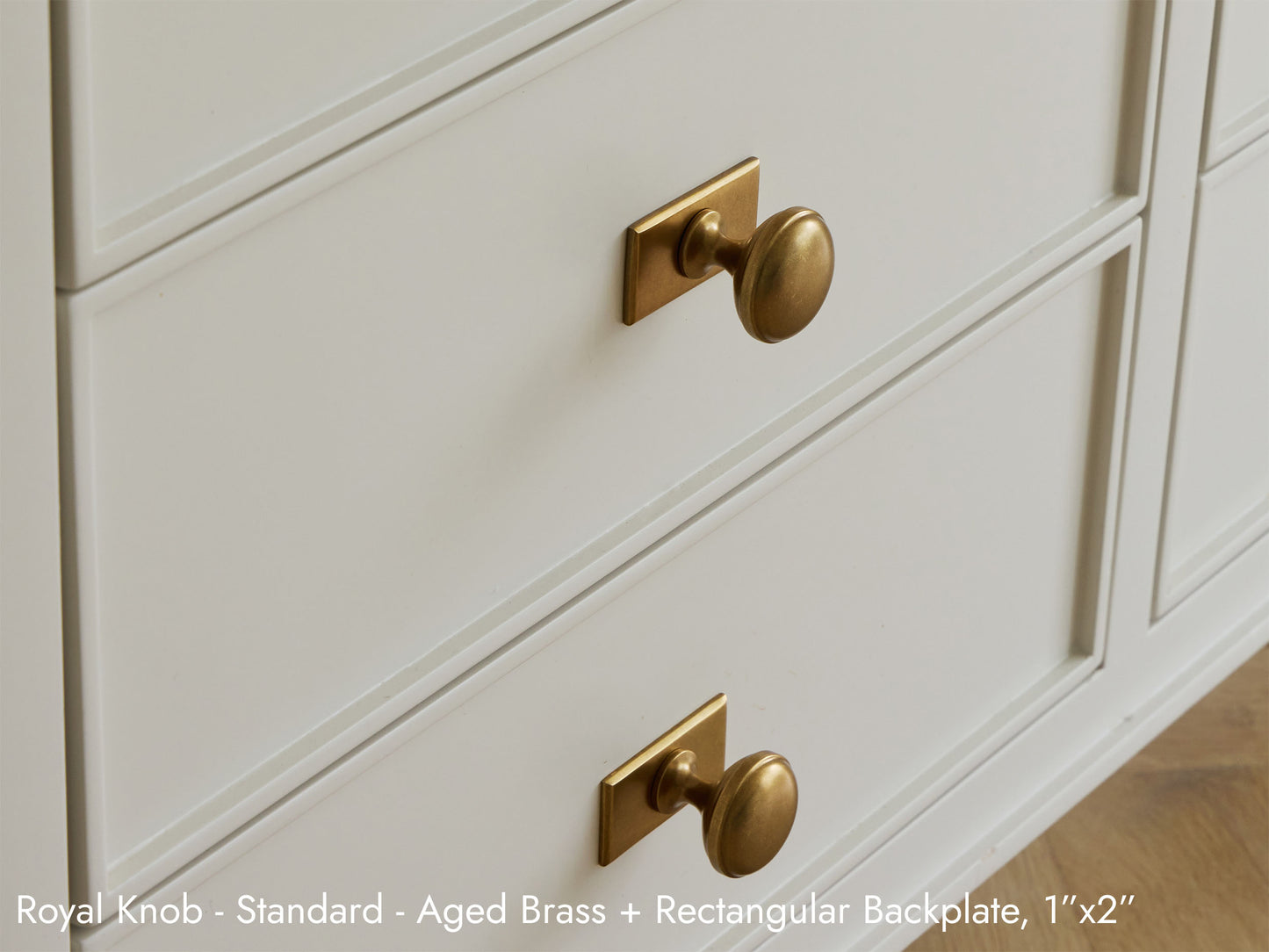 Solid brass Royal Knob in aged brass finish on kitchen cabinets.