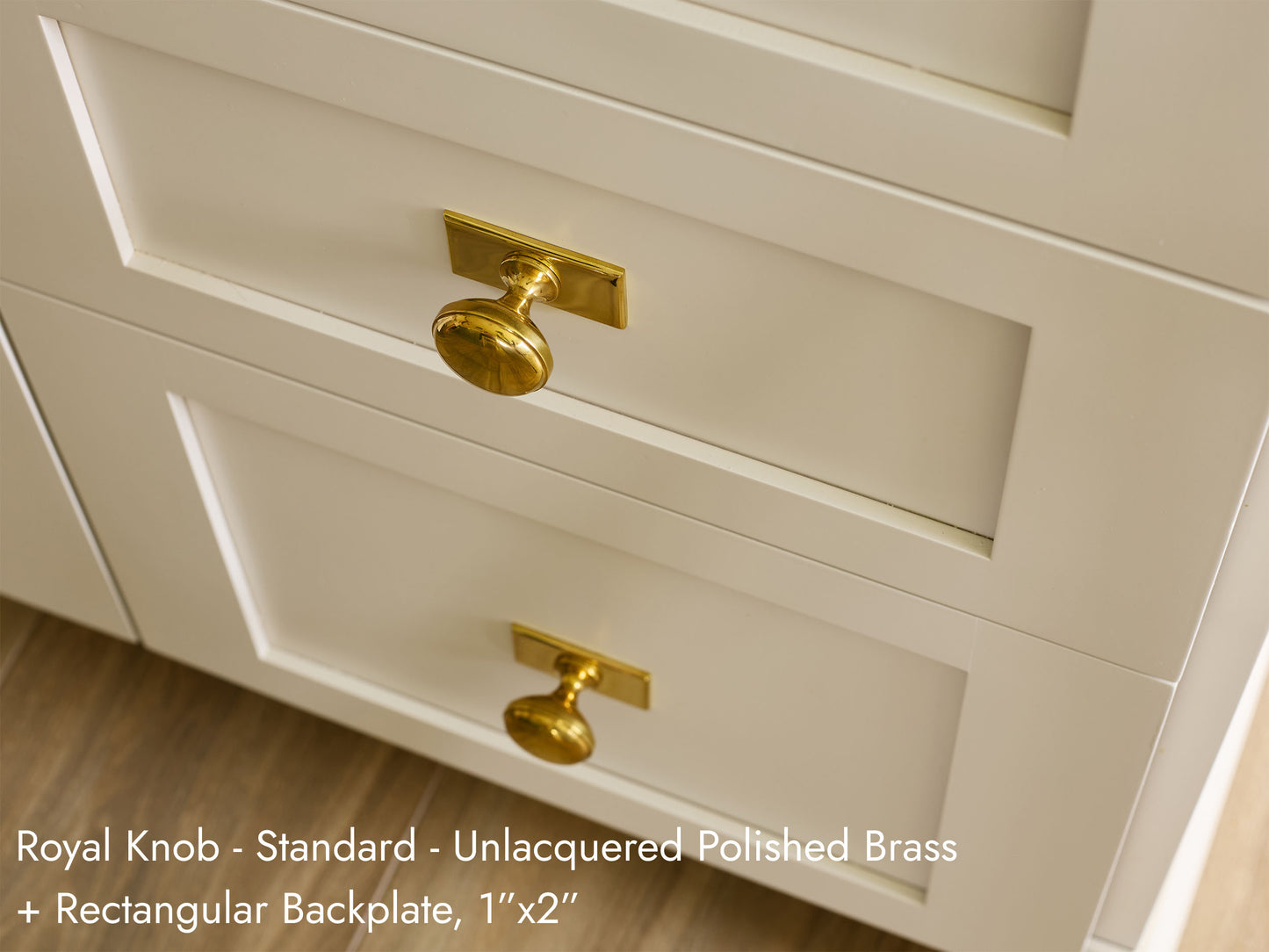 Solid brass Royal Knob, in unlacquered polished brass finish, on kitchen cabinets with Rectangular Backplate.