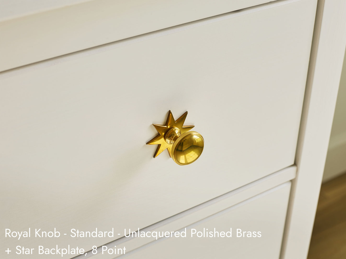 Solid brass Royal Knob, in unlacquered polished brass finish, on kitchen cabinets with Star Backplate.