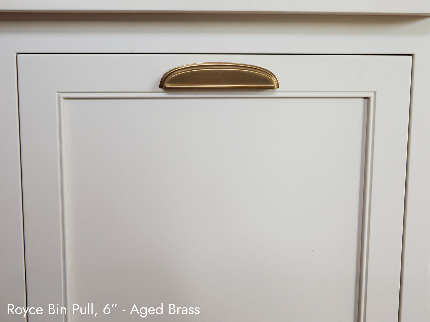 Solid brass Royce Bin Pull, in aged brass finish, on kitchen cabinets.