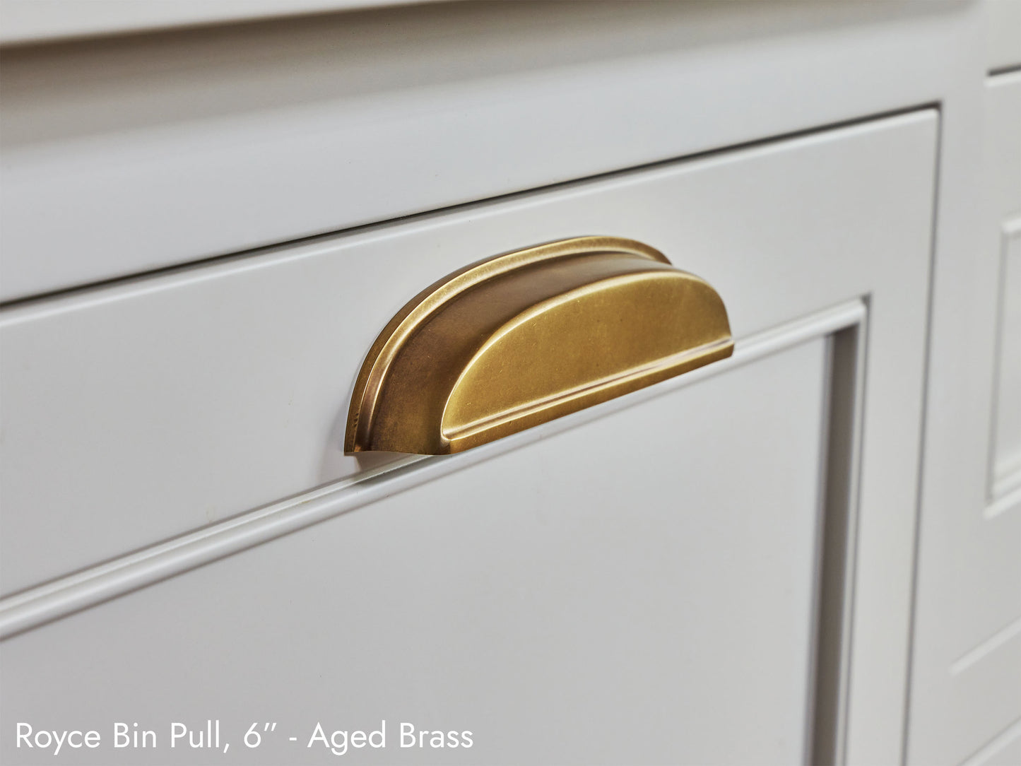 Solid brass Royce Bin Pull, in aged brass, on kitchen cabinets.