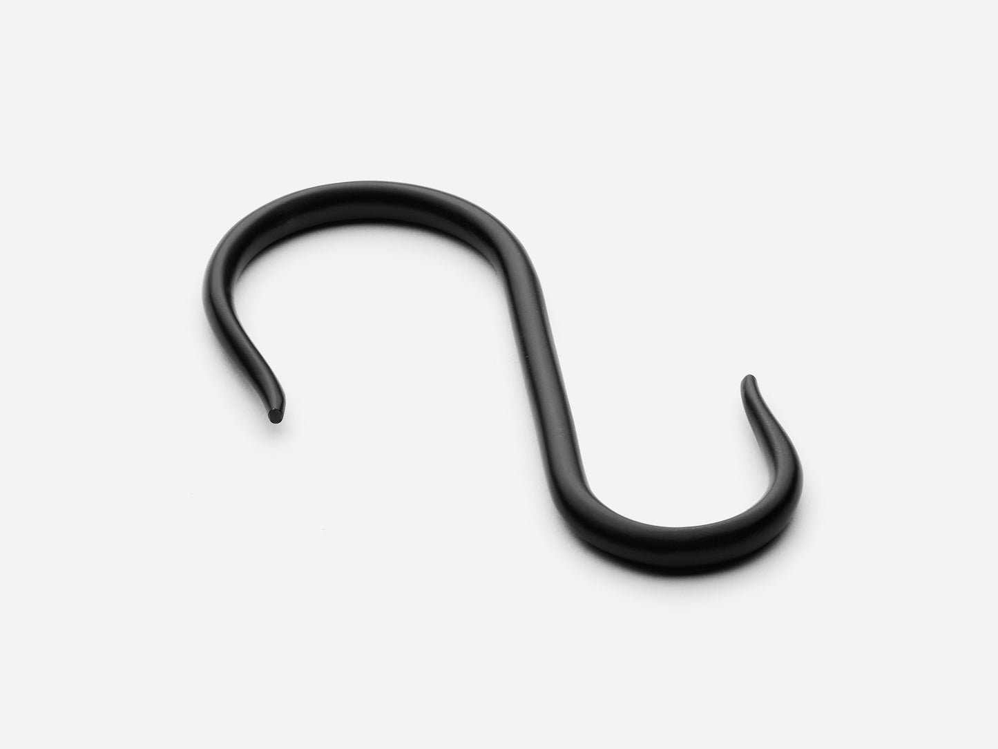 Solid brass S-hook for hanging pot rail in a matte black finish for kitchens.