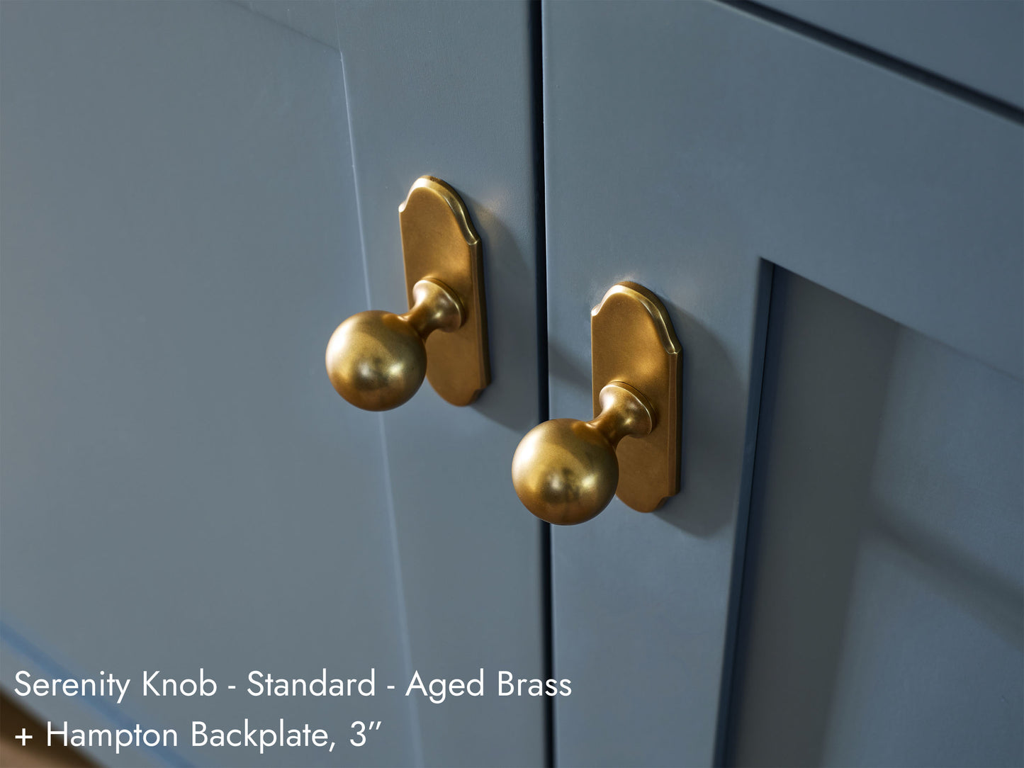 Solid brass Serenity Knobs, in aged brass finish, on kitchen cabinets with Hampton Backplates.